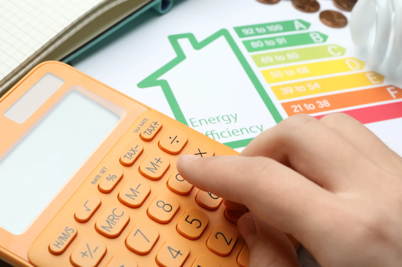 Close-up of calculator and paper with “energy efficient” in background