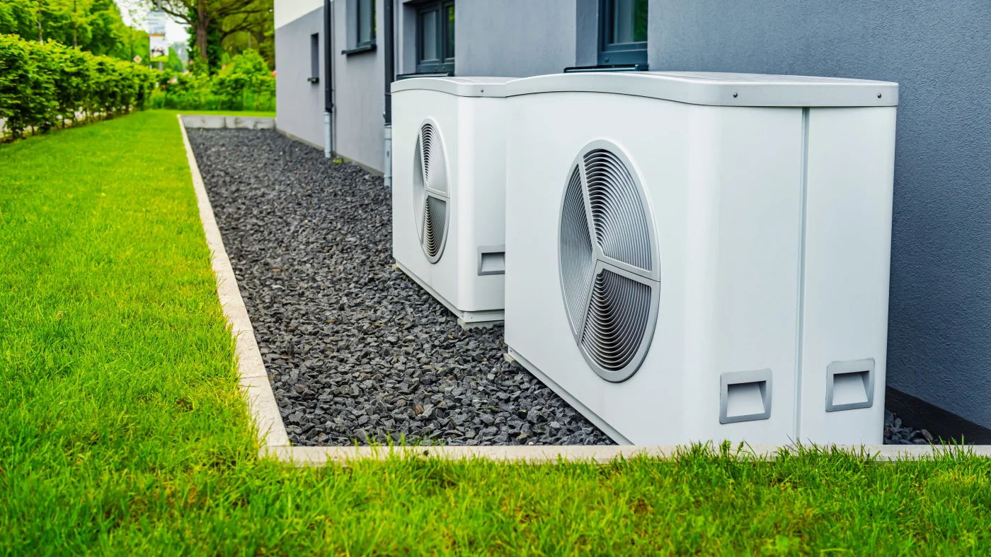 Two heat pumps outside of modern house in the Twin Cities area
