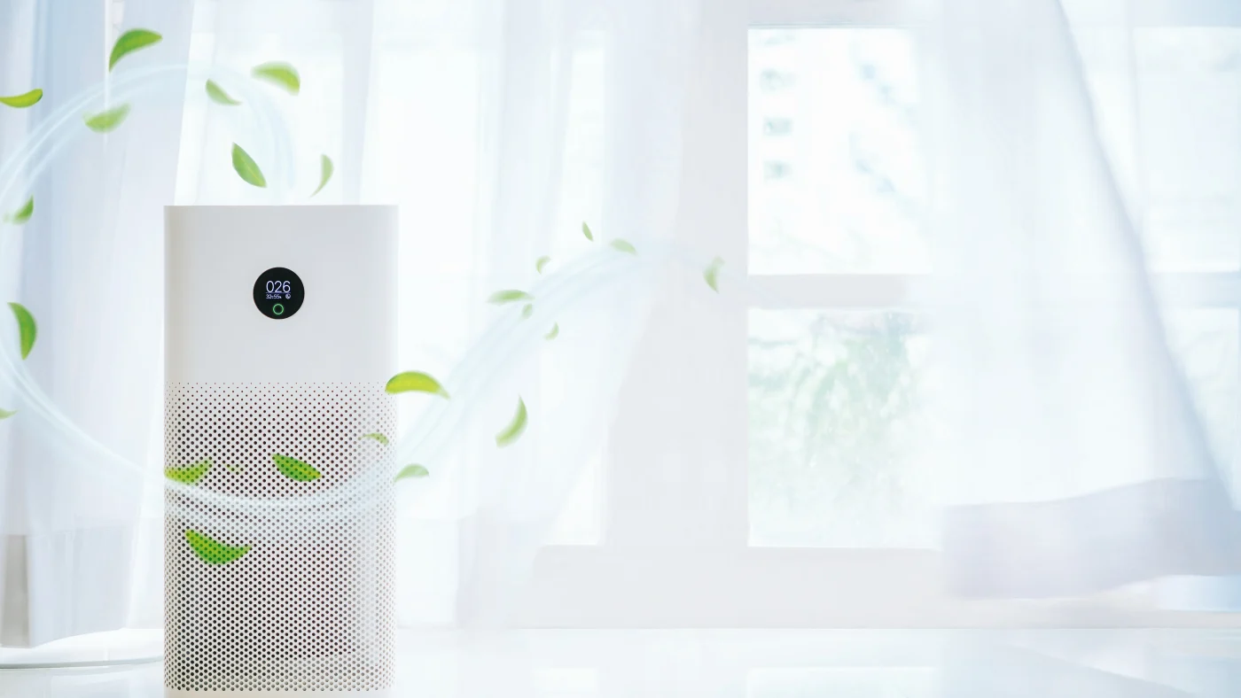 Air purifier in front of white curtains