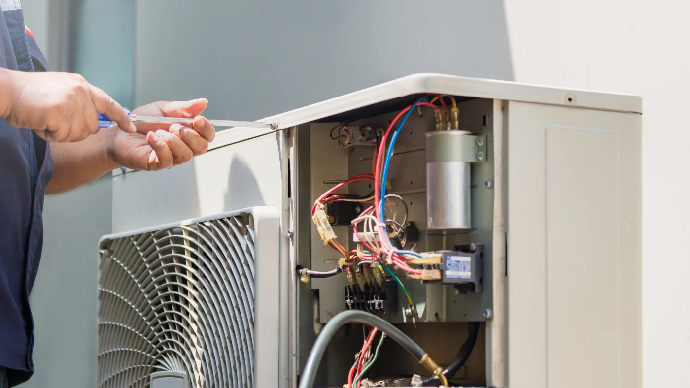 Technician repairing air conditioning unit for Woodbury residence