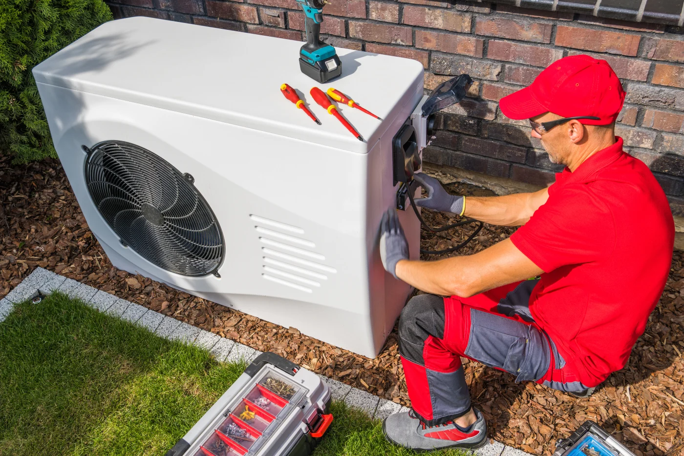 Workers repairing a heat pump