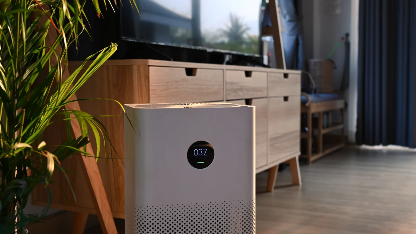 Air purifier sitting in bedroom in front of dresser