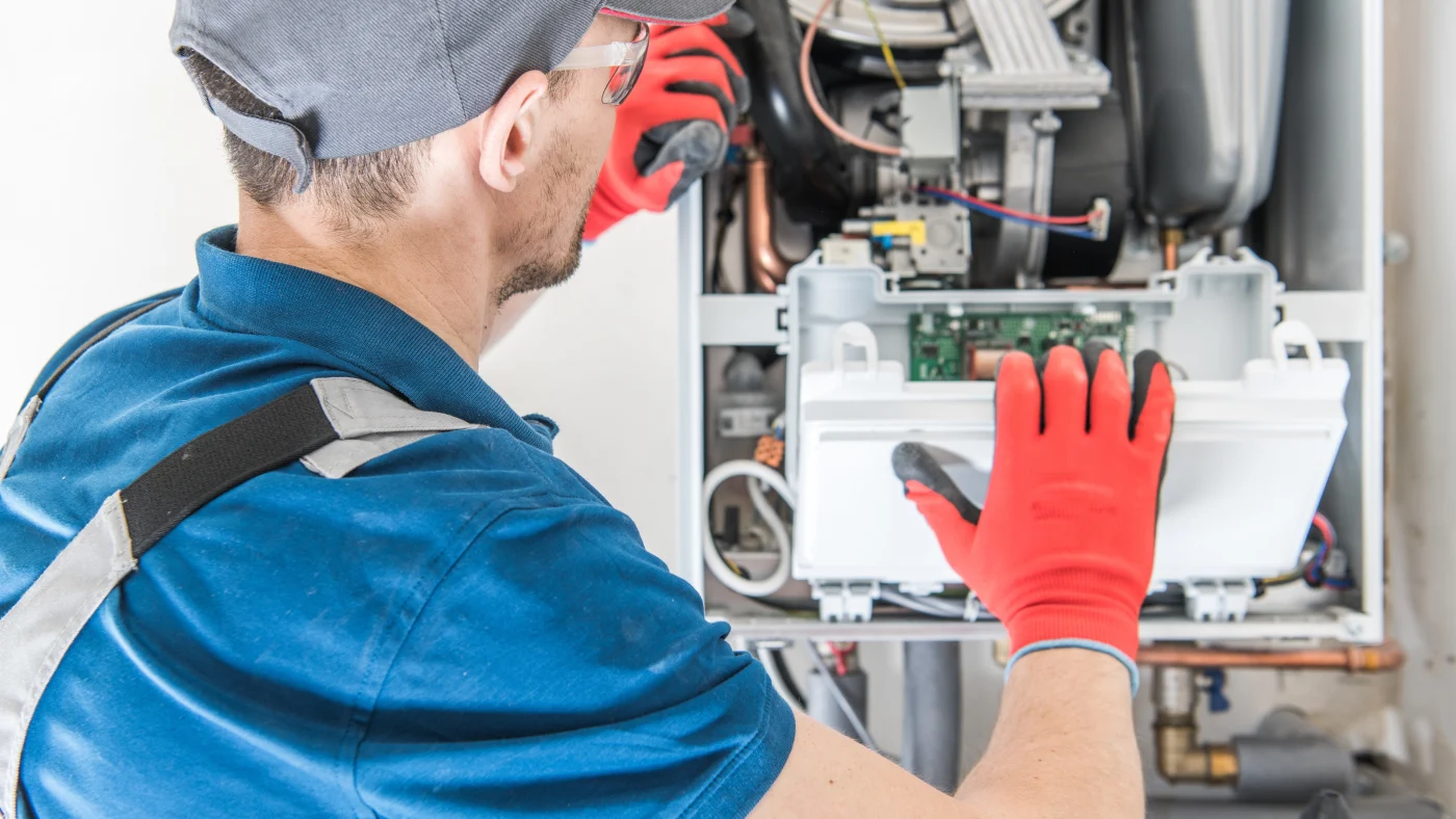 Technician repairing gas furnace