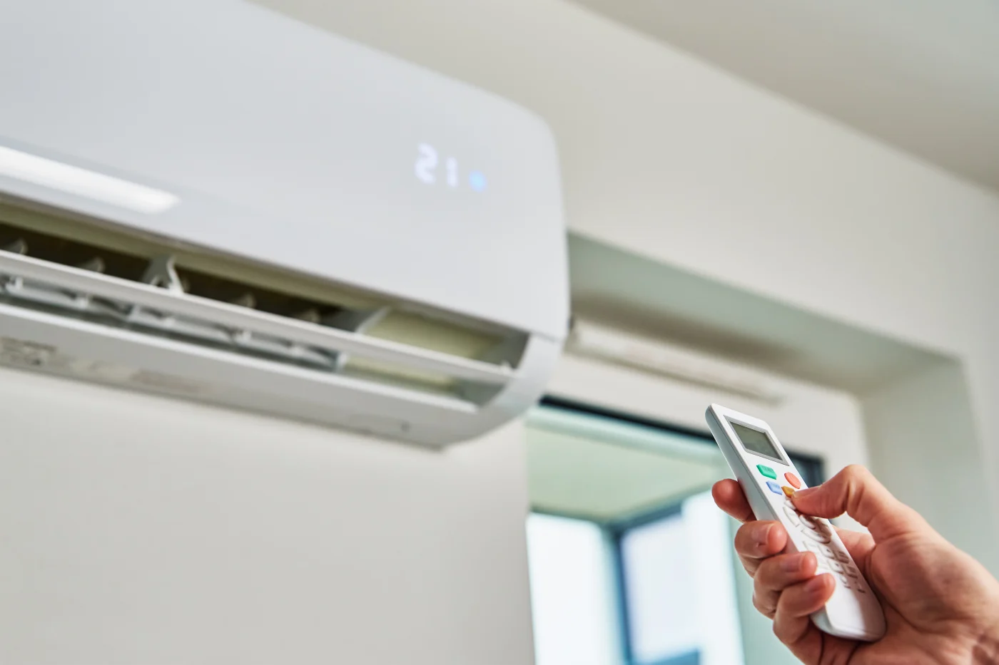 Hand on remote adjusting indoor a/c unit