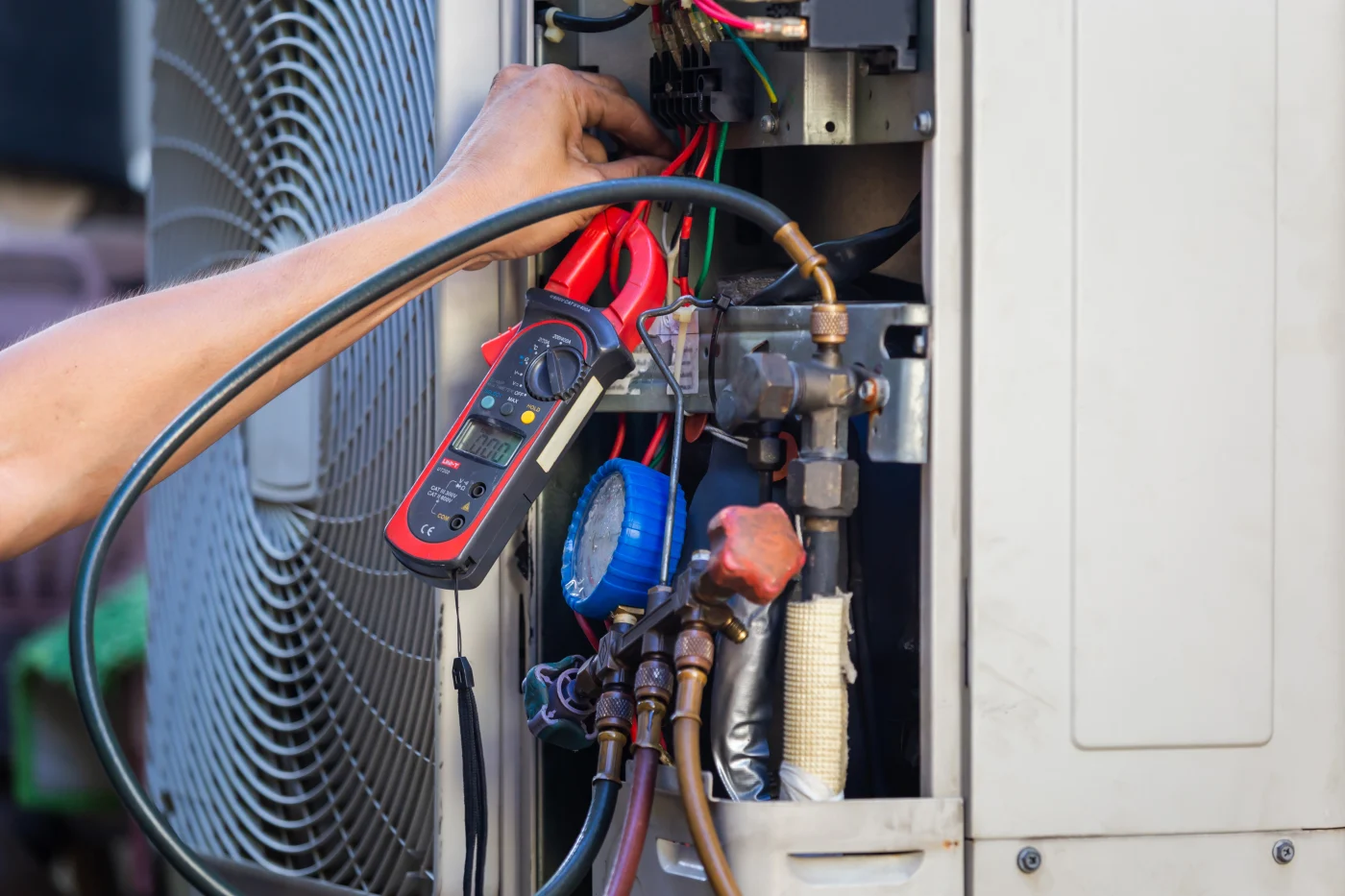 Repairman making air conditioning repairs