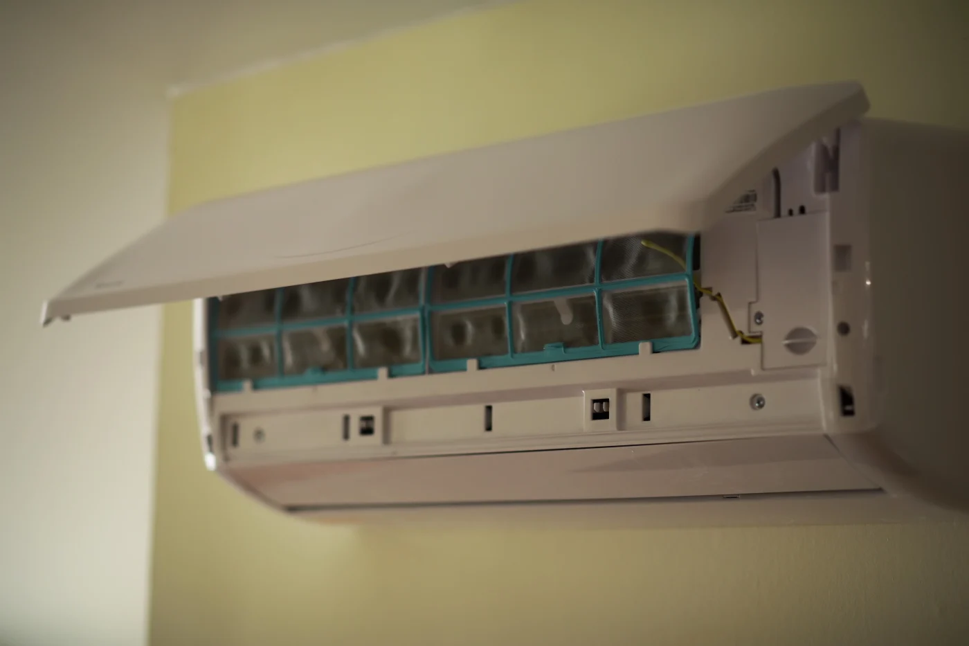 Modern Wall Mounted Air Conditioner Unit In Operation With Open Front Panel