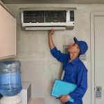 Technicians working on an AC unit.