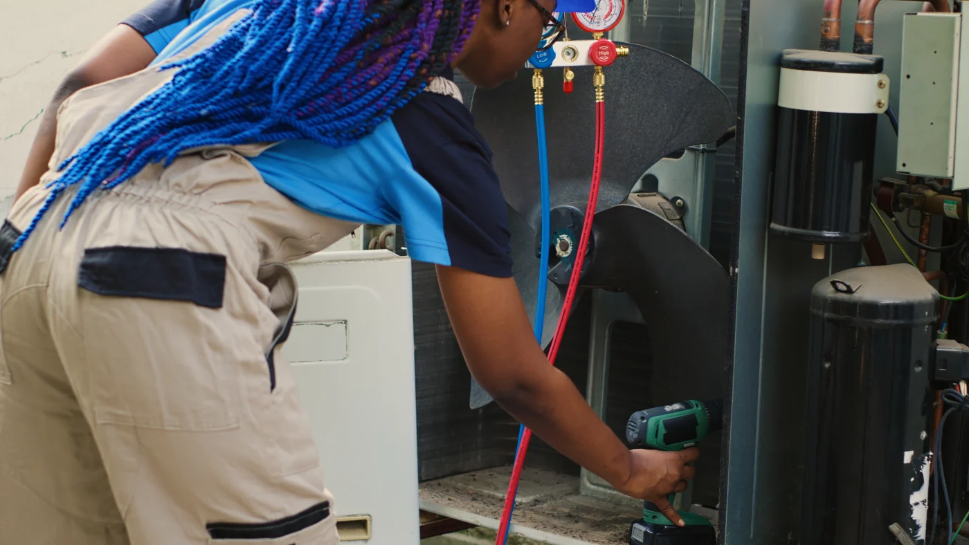 Best Pro AC Service In Cottage Grove, MN | Priority Heating and Cooling Technician performing AC services inside a home